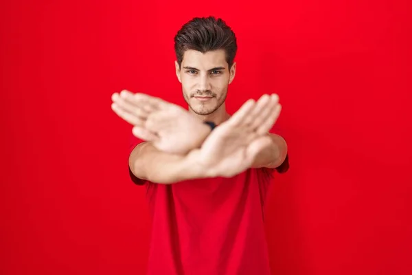 Young Hispanic Man Standing Red Background Rejection Expression Crossing Arms — Stockfoto