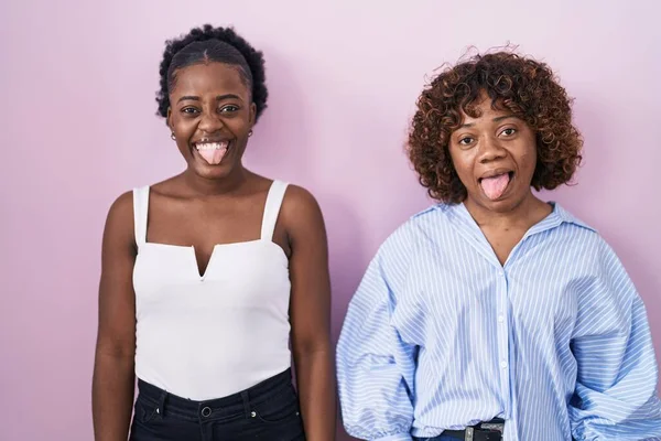 Two African Women Standing Pink Background Sticking Tongue Out Happy — Stock Photo, Image