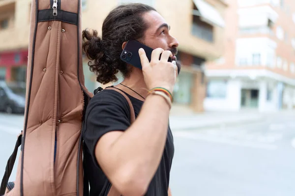 Young Hispanic Man Musician Talking Smartphone Holding Guitar Case Street — Stock fotografie