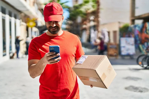 Young Hispanic Man Courier Using Smartphone Holding Package Street — Stock Photo, Image