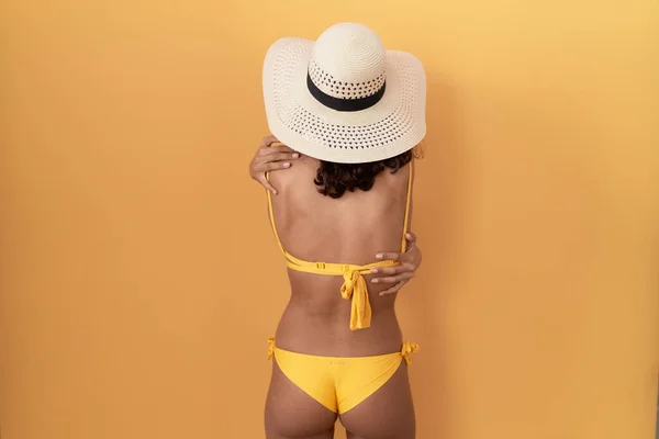 Young Hispanic Woman Wearing Bikini Summer Hat Hugging Oneself Happy — Stock Photo, Image