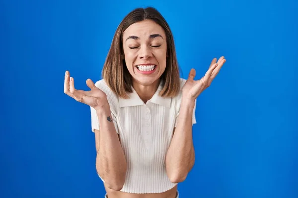 Hispanic Woman Standing Blue Background Celebrating Mad Crazy Success Arms — Foto Stock