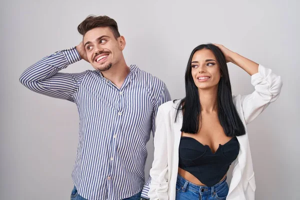 Young Hispanic Couple Standing White Background Smiling Confident Touching Hair — Stock Photo, Image