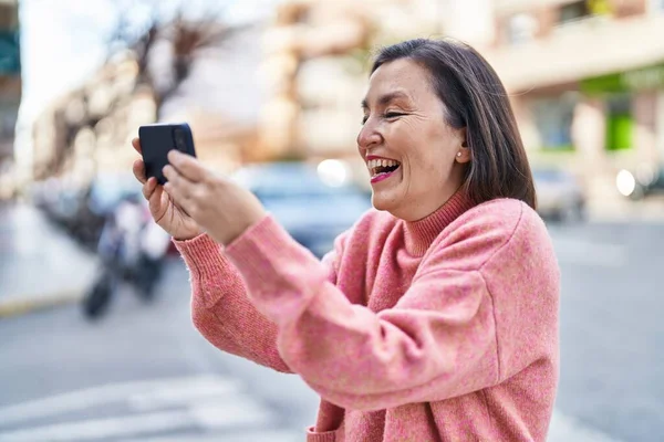 Middle Age Woman Smiling Confident Watching Video Smartphone Street — Stockfoto