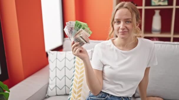 Молода Блондинка Посміхається Впевнено Тримає Російські Рублі Банкноти Вдома — стокове відео