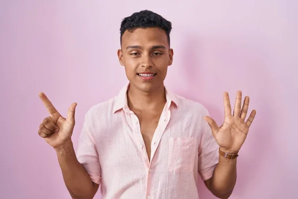 Young Hispanic Man Standing Pink Background Showing Pointing Fingers Number — Stock Photo, Image
