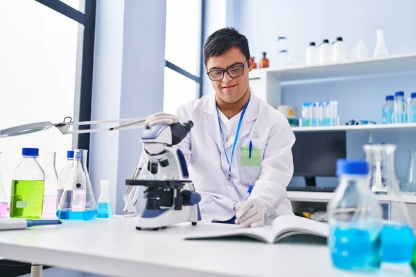 Syndrome Man Wearing Scientist Uniform Using Microscope Writing Notebook Laboratory — Stock Photo, Image