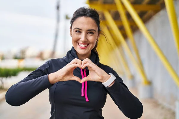 Young Hispanic Woman Wearing Sportswear Doing Heart Symbol Hands Street — Stock fotografie