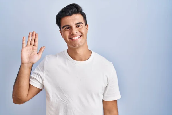 Hispanic Man Standing Blue Background Waiving Saying Hello Happy Smiling — Stock Photo, Image