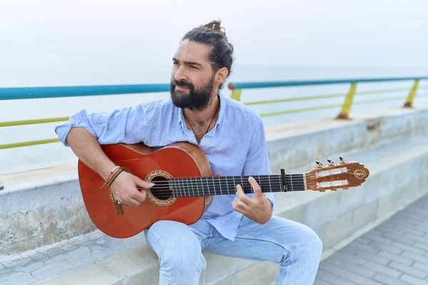 Young Hispanic Man Musician Playing Classical Guitar Sitting Bench Seaside — Stock Fotó