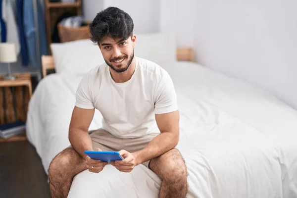 Young Hispanic Man Using Touchpad Sitting Bed Bedroom — Stok fotoğraf