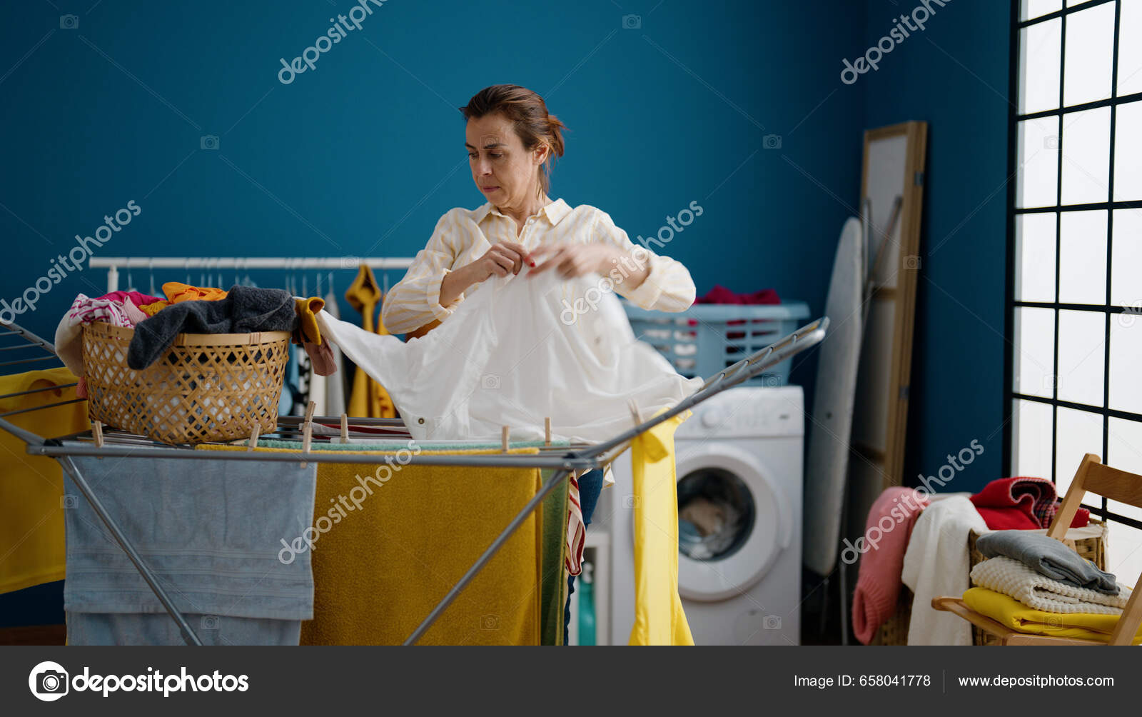Middle Age Hispanic Woman Hanging Clothes Clothesline Laundry Room