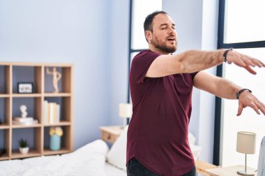 Young hispanic man somnambulist sleepwalking at bedroom