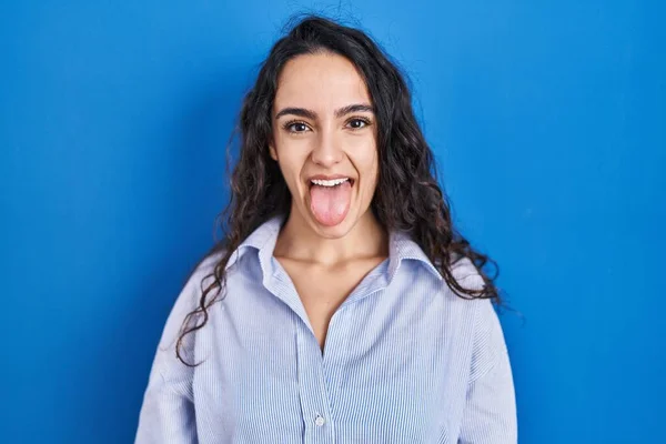 Young Brunette Woman Standing Blue Background Sticking Tongue Out Happy —  Fotos de Stock
