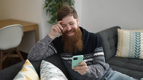 Young Redhead Man Using Smartphone Sitting Sofa Home — Photo