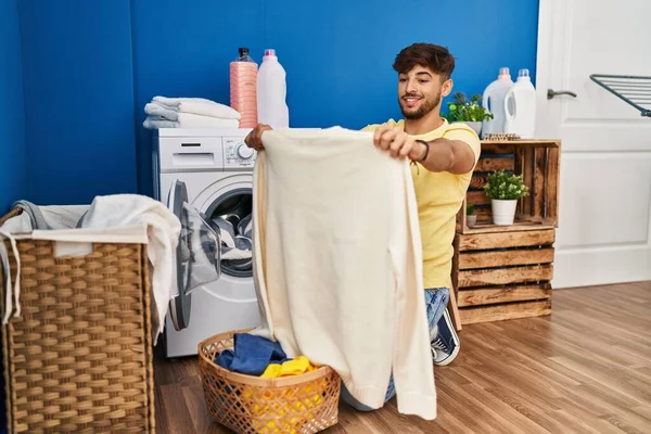 Young Arab Man Holding Sweater Washing Clothes Laundry Room — Stock Fotó