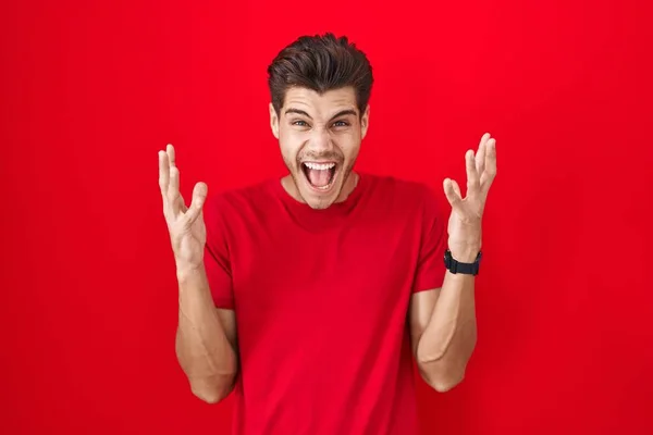 Young Hispanic Man Standing Red Background Celebrating Mad Crazy Success —  Fotos de Stock