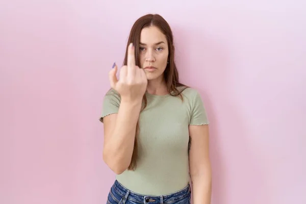 Beautiful Brunette Woman Standing Pink Background Showing Middle Finger Impolite — стоковое фото