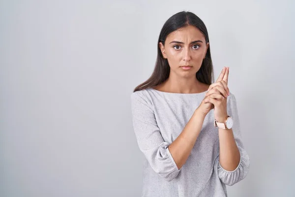 Young Hispanic Woman Standing White Background Holding Symbolic Gun Hand — Stockfoto