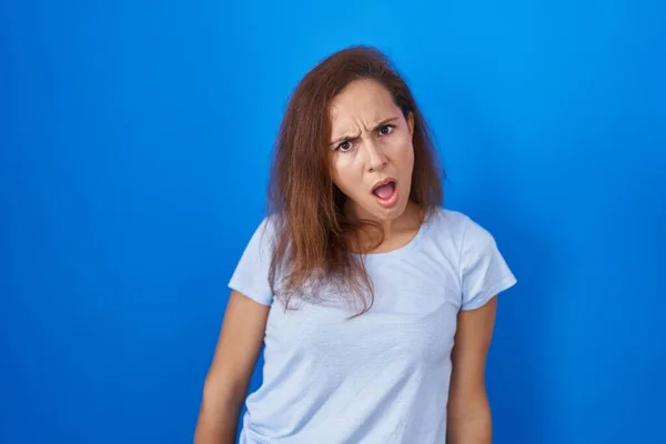 Brunette Woman Standing Blue Background Shock Face Looking Skeptical Sarcastic — Stock Photo, Image