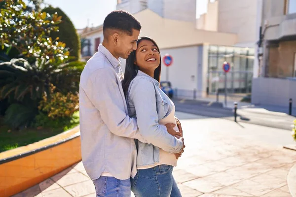 Young Latin Couple Expecting Baby Hugging Each Other Standing Park — Fotografia de Stock