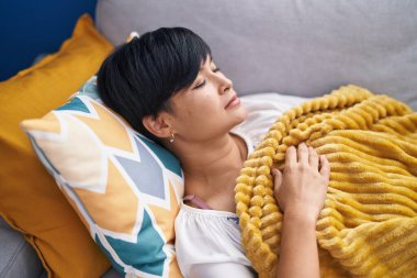 Middle age chinese woman lying on bed sleeping at home