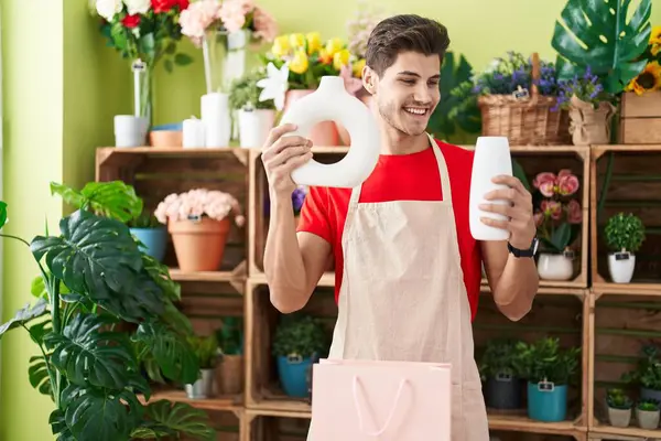 Jonge Spaanse Man Bloemist Glimlachend Zelfverzekerde Holding Plant Potten Bloemenwinkel — Stockfoto