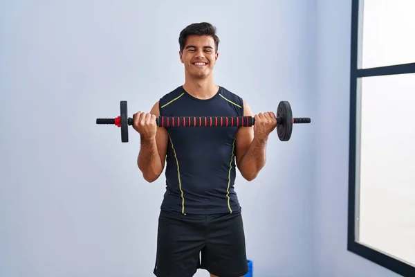 Young Hispanic Man Smiling Confident Using Bar Disc Training Sport — Stockfoto