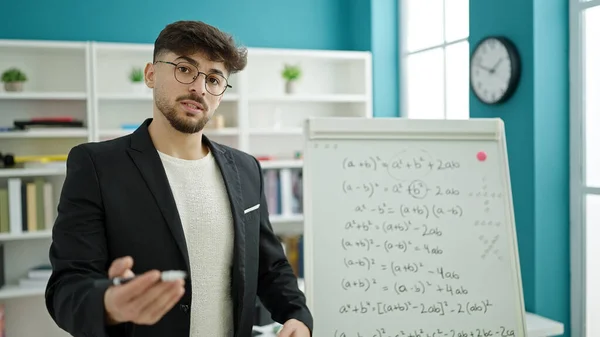Young arab man teacher teaching maths lesson at university classroom