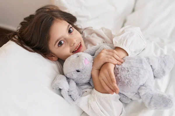 Adorable Hispanic Girl Hugging Doll Lying Bed Bedroom — Stock Photo, Image