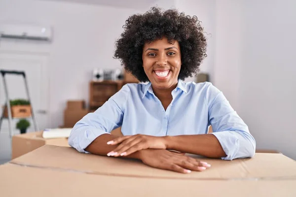 African American Woman Smiling Confident Leaning Package New Home — Stok fotoğraf