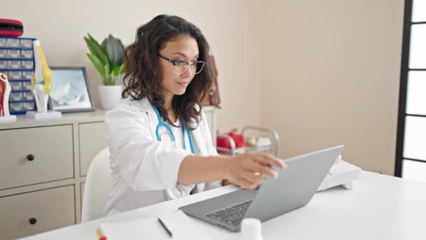 Young Beautiful Hispanic Woman Doctor Opening Laptop Working Clinic — Stock Video