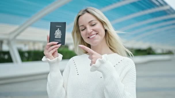 Молодая Блондинка Улыбается Уверенно Указывая Канадский Паспорт Парке — стоковое видео