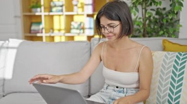 Genç, güzel, İspanyol bir kadın işini bitirip evde televizyon seyrediyor.