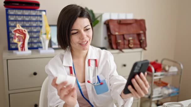Νεαρή Καυκάσια Γυναίκα Γιατρός Χαμογελά Βιντεοκλήση Smartphone Στην Κλινική — Αρχείο Βίντεο