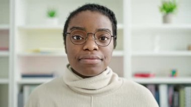 African american woman student smiling confident standing at library university