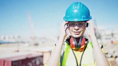 Young beautiful hispanic woman architect smiling confident standing at street
