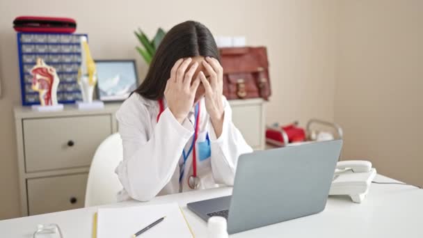 Young Beautiful Hispanic Woman Doctor Stressed Using Laptop Working Clinic — Vídeos de Stock