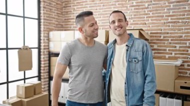 İki adam, işyerinde çalışanların güvenini kazanmak için gülümsüyor.