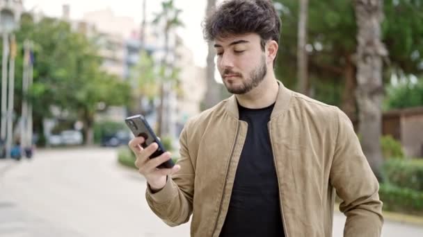Jonge Spaanse Man Met Smartphone Met Winnaarsuitdrukking Het Park — Stockvideo