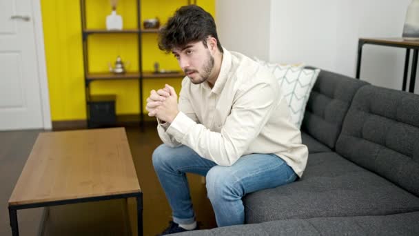 Young Hispanic Man Stressed Sitting Sofa Home — ストック動画