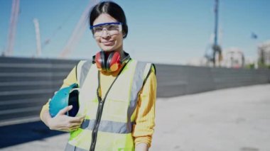 Young beautiful hispanic woman architect smiling confident standing at street