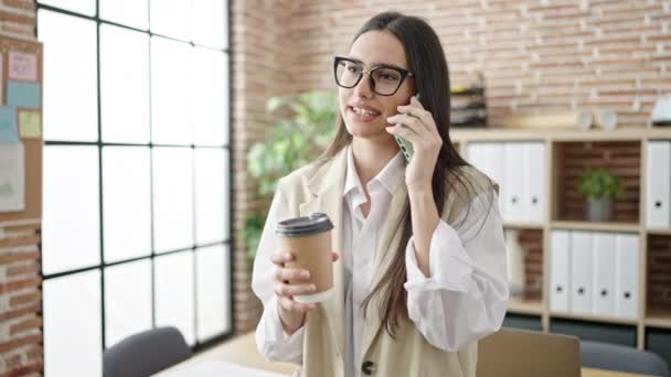 Young Beautiful Hispanic Woman Business Worker Talking Smartphone Drinking Coffee — Vídeos de Stock