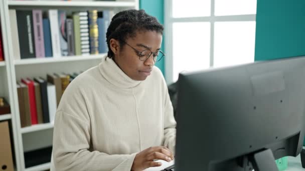 African American Woman Student Using Computer Stressed Library University — Stockvideo