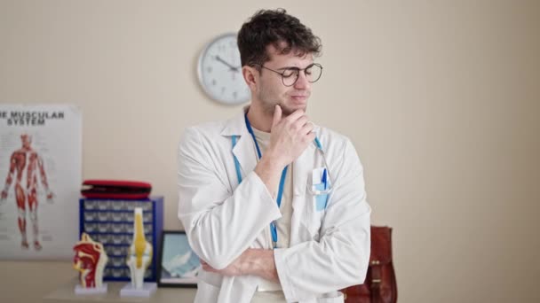 Young Hispanic Man Doctor Standing Doubt Expression Thinking Clinic — Stock Video