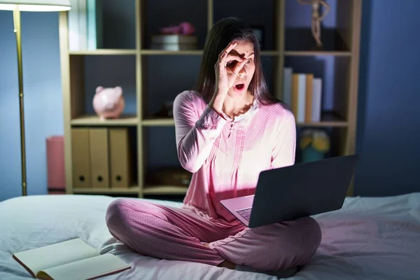 Young Hispanic Woman Using Computer Laptop Bed Doing Gesture Shocked — Stock Photo, Image
