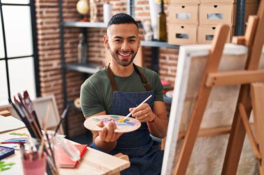 African american man artist smiling confident drawing at art studio