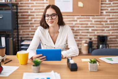 Young woman business worker using touchpad working at office