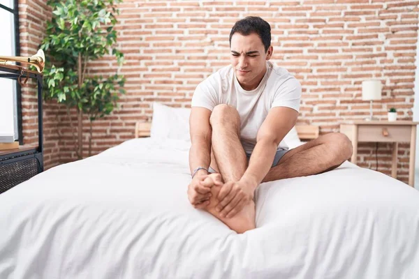 Young Hispanic Man Suffering Feet Pain Sitting Bed Bedroom — Stock Photo, Image