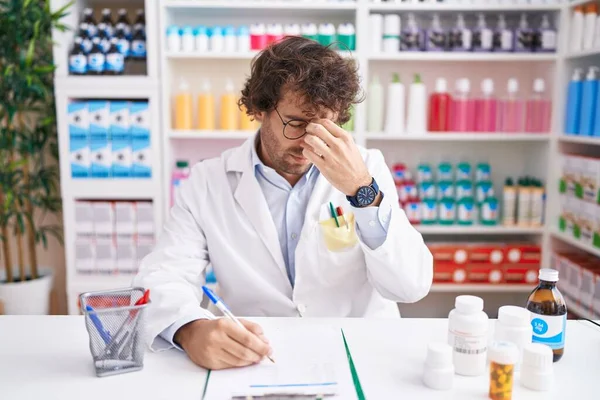 Hispanic Young Man Working Pharmacy Drugstore Tired Rubbing Nose Eyes — Stock Photo, Image